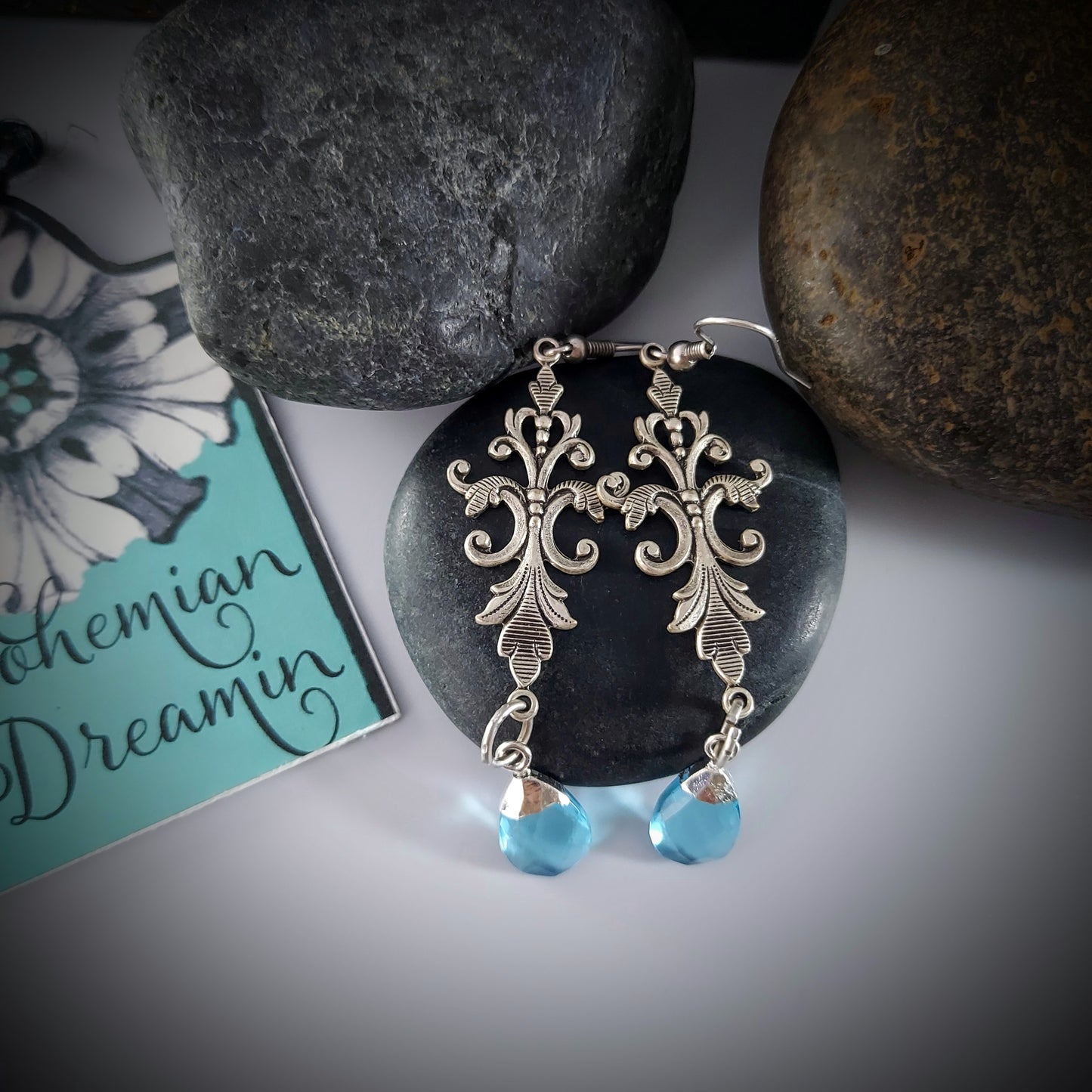 Created in our studio, these unique earrings are lightweight and so beautiful to wear! The stunning Blue Topaz dangles from an Art Nouveau Style Filigree base. Really lovely on!
 
Comes in a Black Velvet drawstring bag for safe keeping, or gifting.

 2.5" length with hooks

Genuine Labradorite and Amazonite, Brass